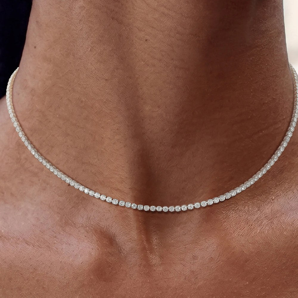 The Pomence Tennis Necklace in the silver tone colorway worn high on the collarbone