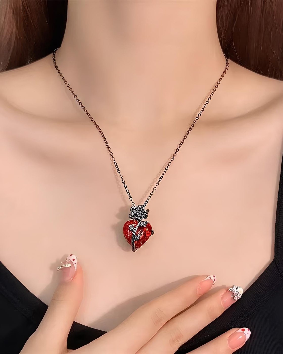 A woman wearing the Pomence Blood Rose Necklace at her collarbone
