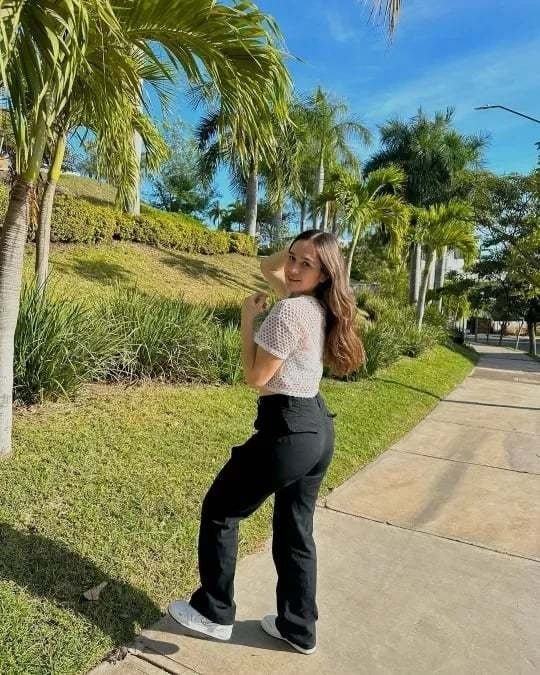 Woman in black cargo pants dressed up for an evening out