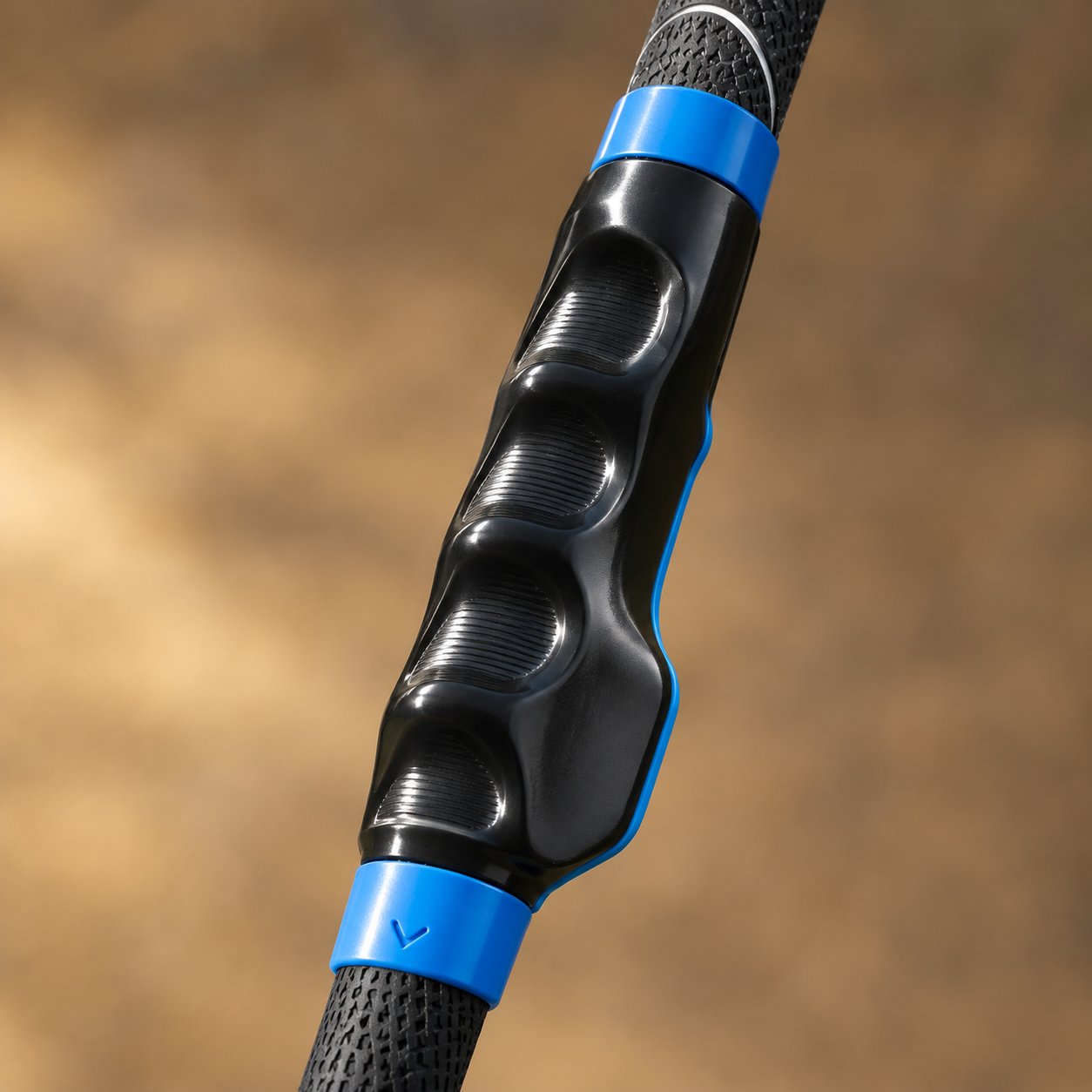 Macro view of the molded finger channels running along the black body of the grip trainer