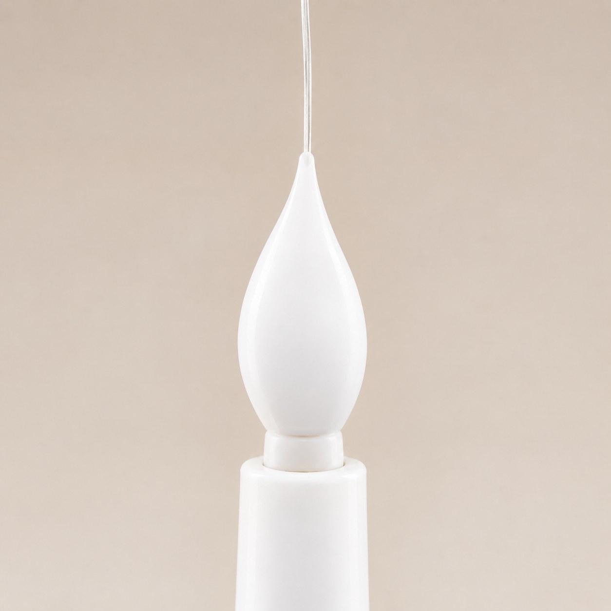 The flame-shaped LED tip of a Pomence LED Floating Candle with the clear line threaded through it