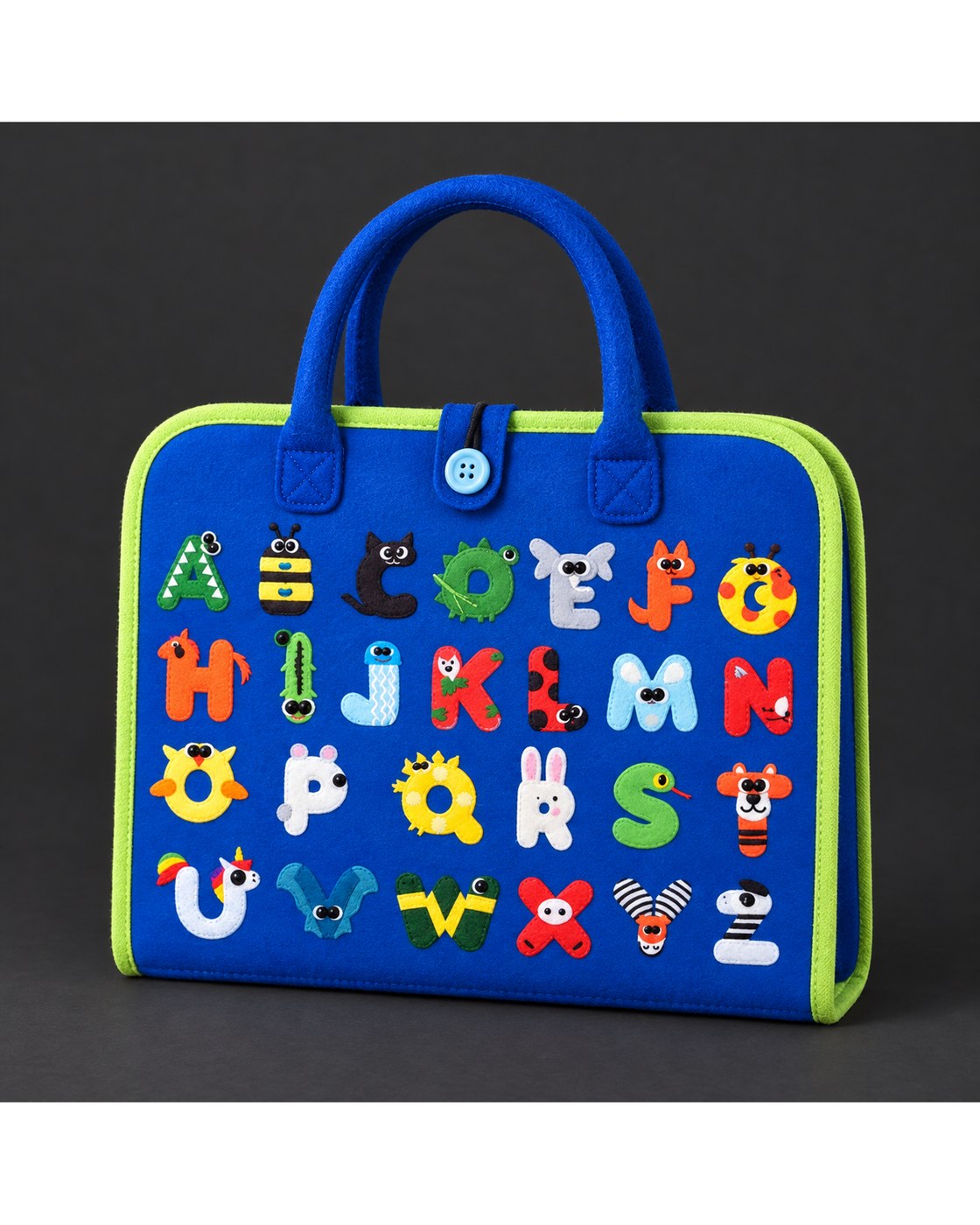 The Pomence Montessori Busy Board closed in a front three-quarter view on a dark charcoal background, its felt tab and button closure on the front panel