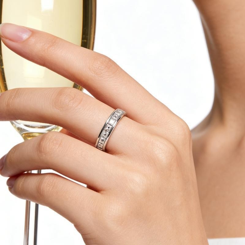 Spinner ring worn on a hand, shown from the side