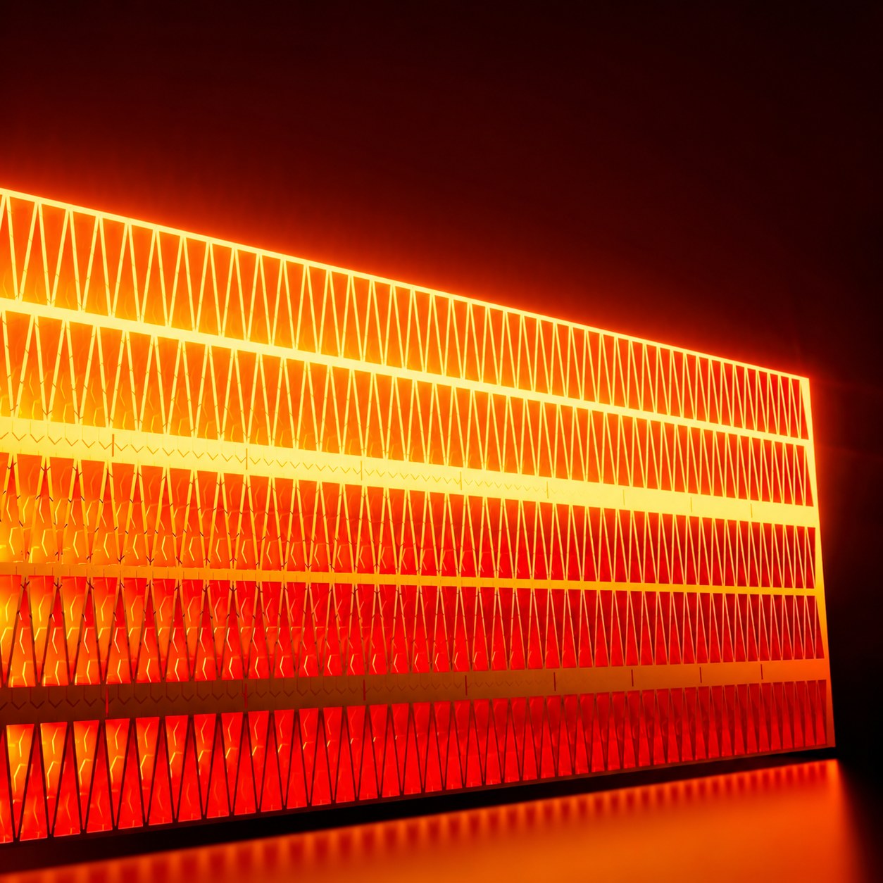 The ceramic heating element of the Pomence Wall Outlet Heater glowing orange