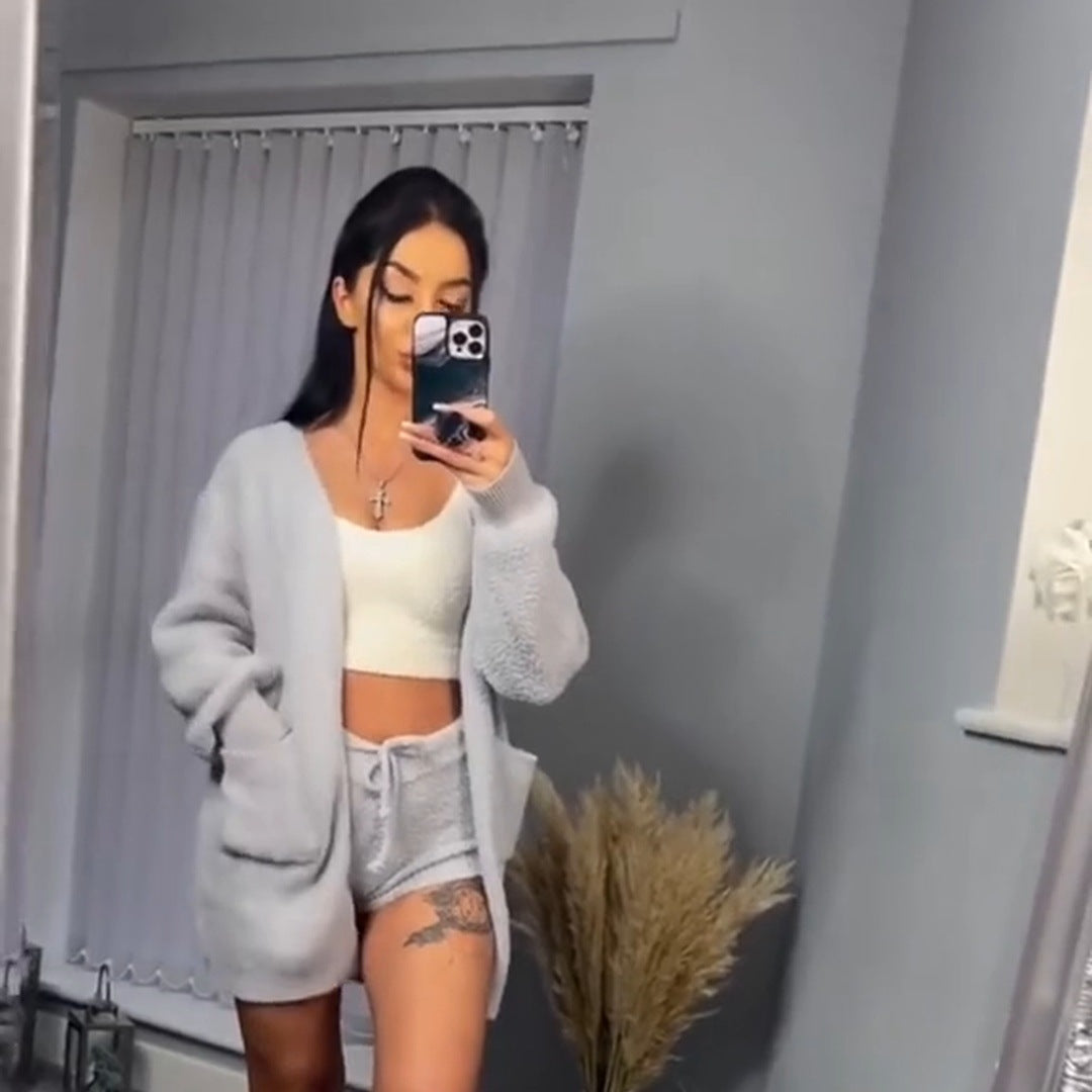 Real frame: a woman's full-length mirror try-on in the Gray 3 Piece Set, the long cardigan open over the ivory crop tank and the drawstring shorts, standing relaxed.