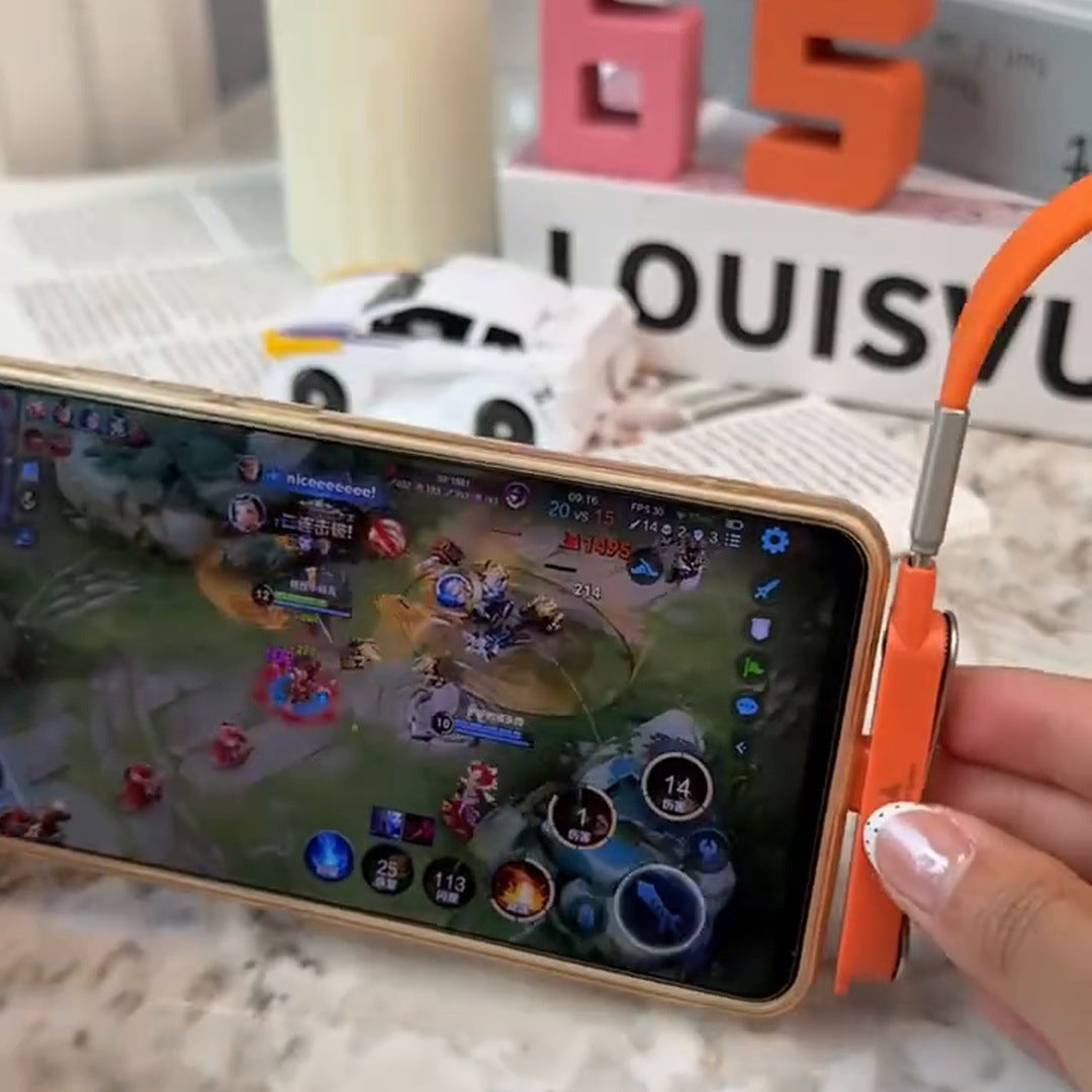 real frame: phone standing sideways on the orange plug playing a game on a marble desk