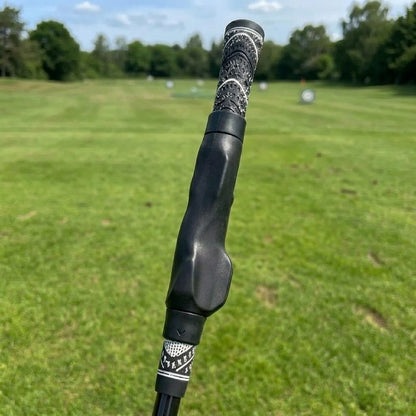 Pomence Golf Grip Trainer with black collars, clipped onto a golf club grip