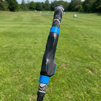 Pomence Golf Grip Trainer with blue collars, clipped onto a golf club grip
