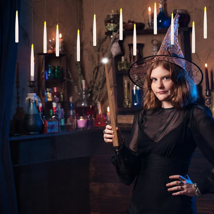 A woman in a pointed hat holding the wand remote under the Pomence LED Floating Candles