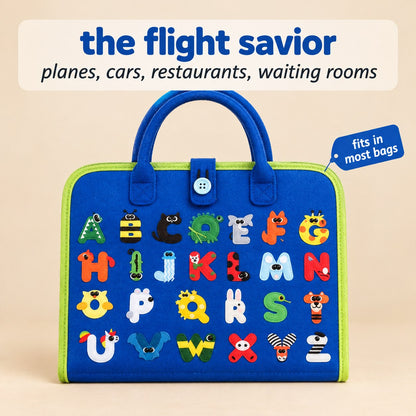 The Pomence Montessori Busy Board closed on a warm beige seamless background, its royal blue front cover printed with an animal alphabet grid, showing how small it packs