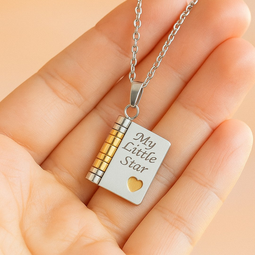 Pomence My Little Star Book Locket Necklace in Silver held in an open palm