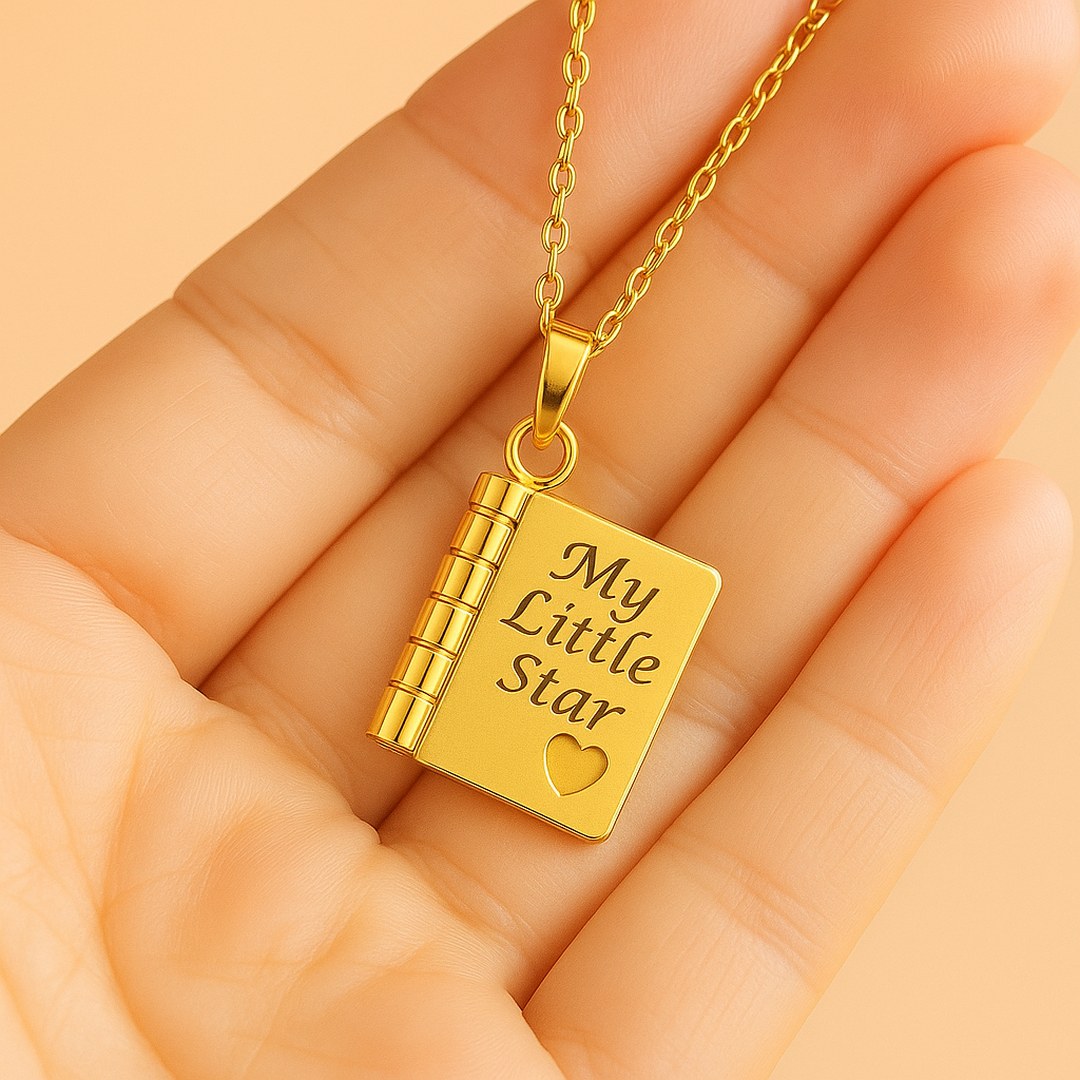 Pomence My Little Star Book Locket Necklace in Gold held in an open palm