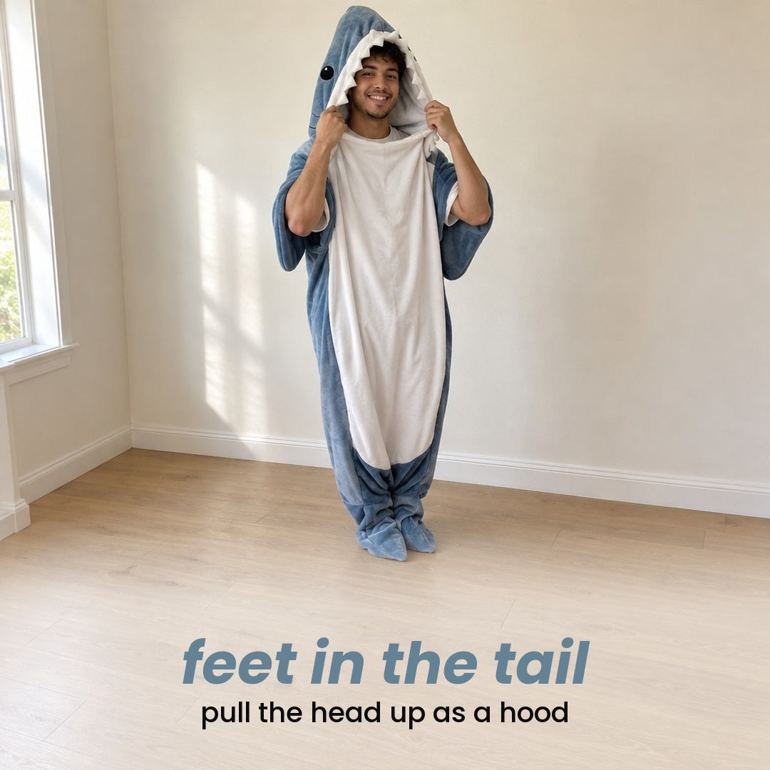 feet in the tail, pull the head up as a hood: a man standing at home in the shark blanket