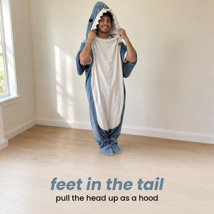 feet in the tail, pull the head up as a hood: a man standing at home in the shark blanket