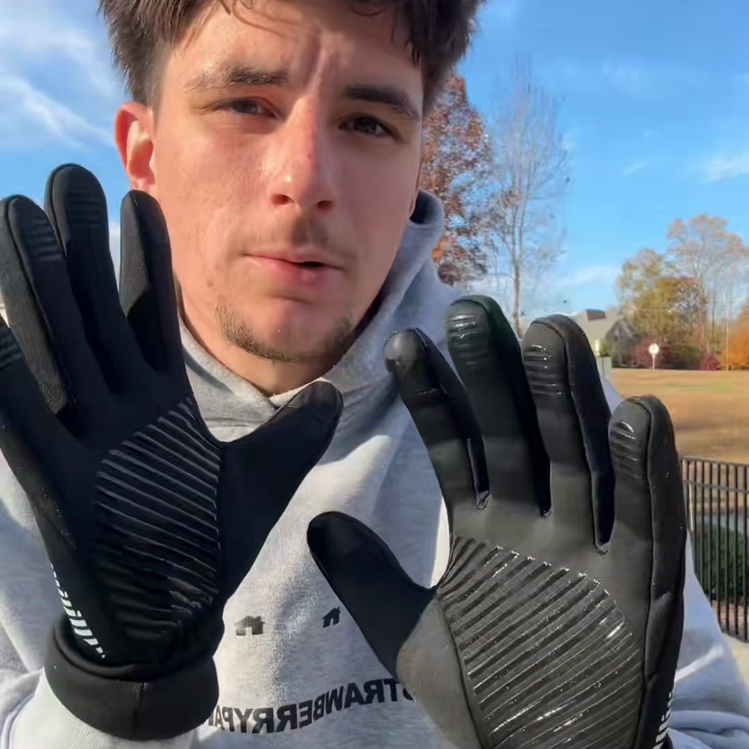 Both open gloved palms held up to camera against a blue sky, the silicone grip lines sharp on both palms, his whole face centred between them.
