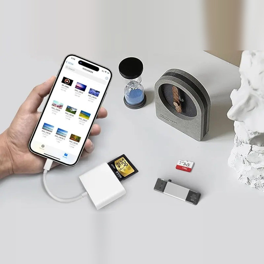 The listing's own photo: a hand holds a USB-C iPhone showing a camera folder in Files, the reader plugged in on its short cable with an SD card beside it, on a light gray table.