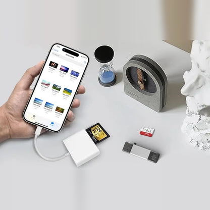 The listing's own photo: a hand holds a USB-C iPhone showing a camera folder in Files, the reader plugged in on its short cable with an SD card beside it, on a light gray table.