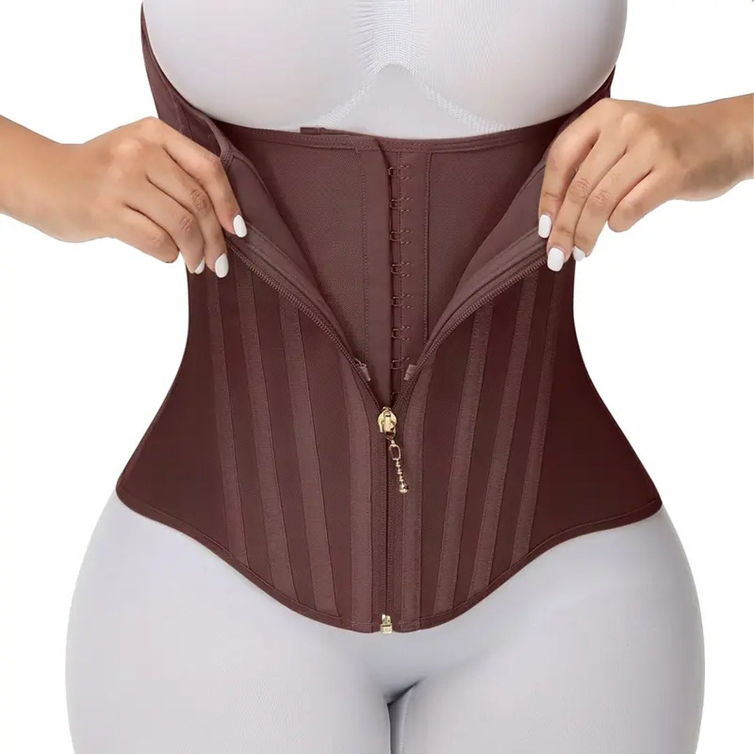 The mocha corset worn on the torso, hands opening the zipper to show the hooks inside.