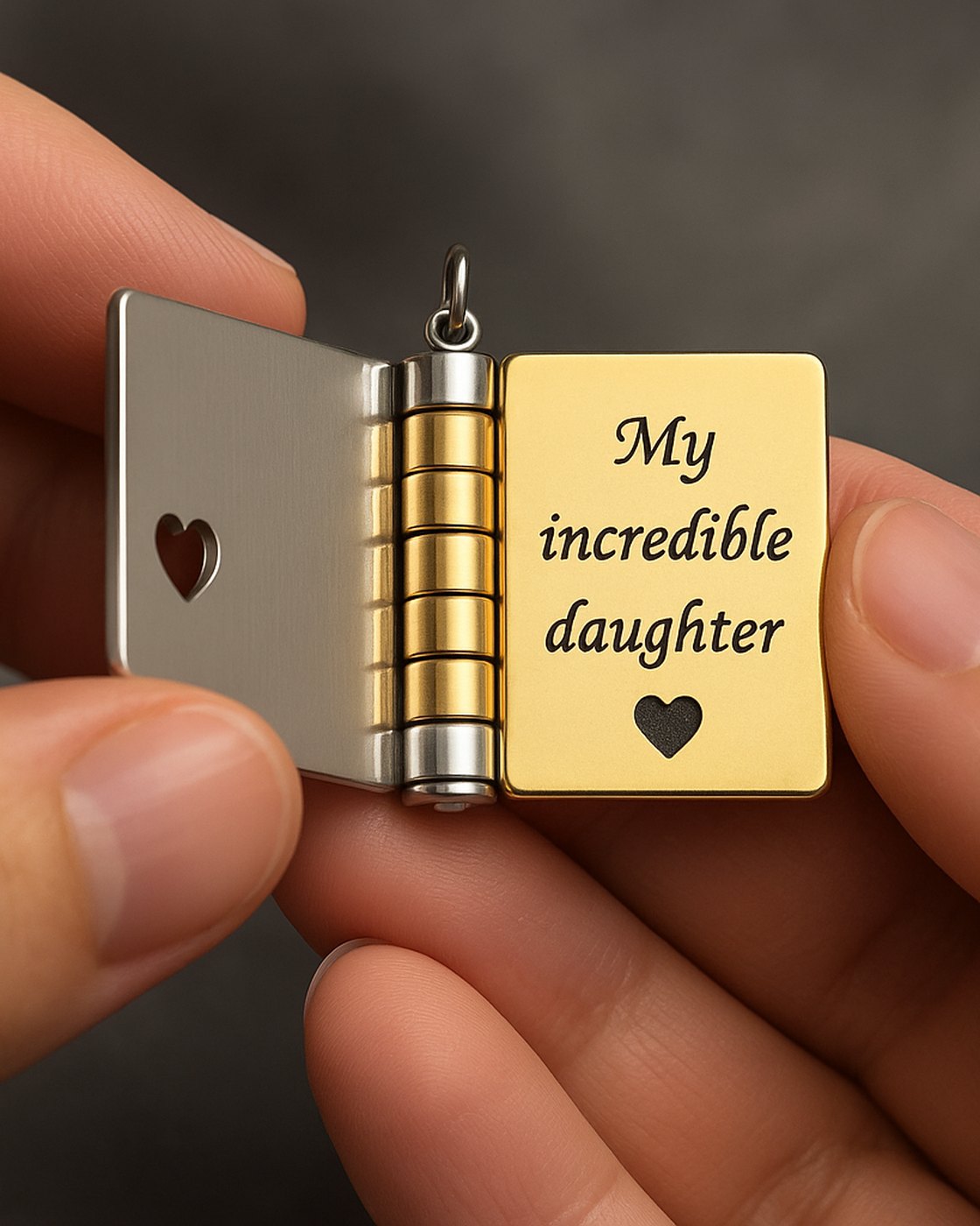 Hands opening the Pomence My Little Star Book Locket Necklace to its first page, My incredible daughter