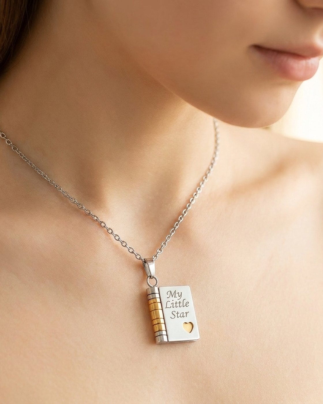 A woman wearing the Pomence My Little Star Book Locket Necklace at her collarbone