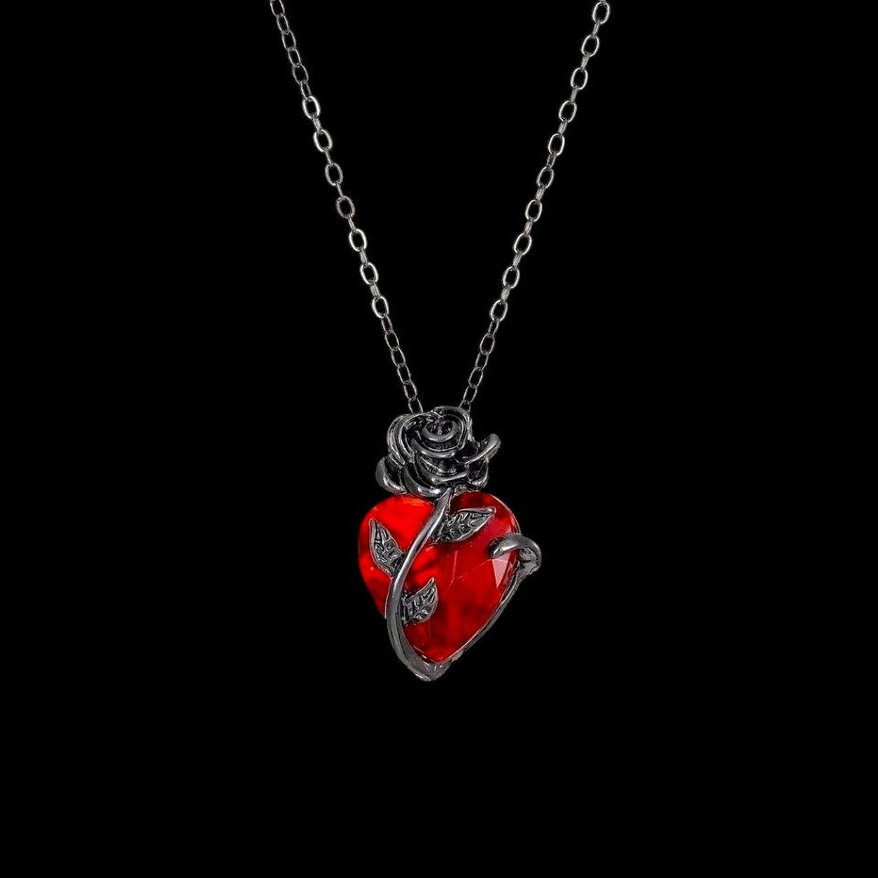 The Pomence Blood Rose Necklace hanging on its fine cable chain
