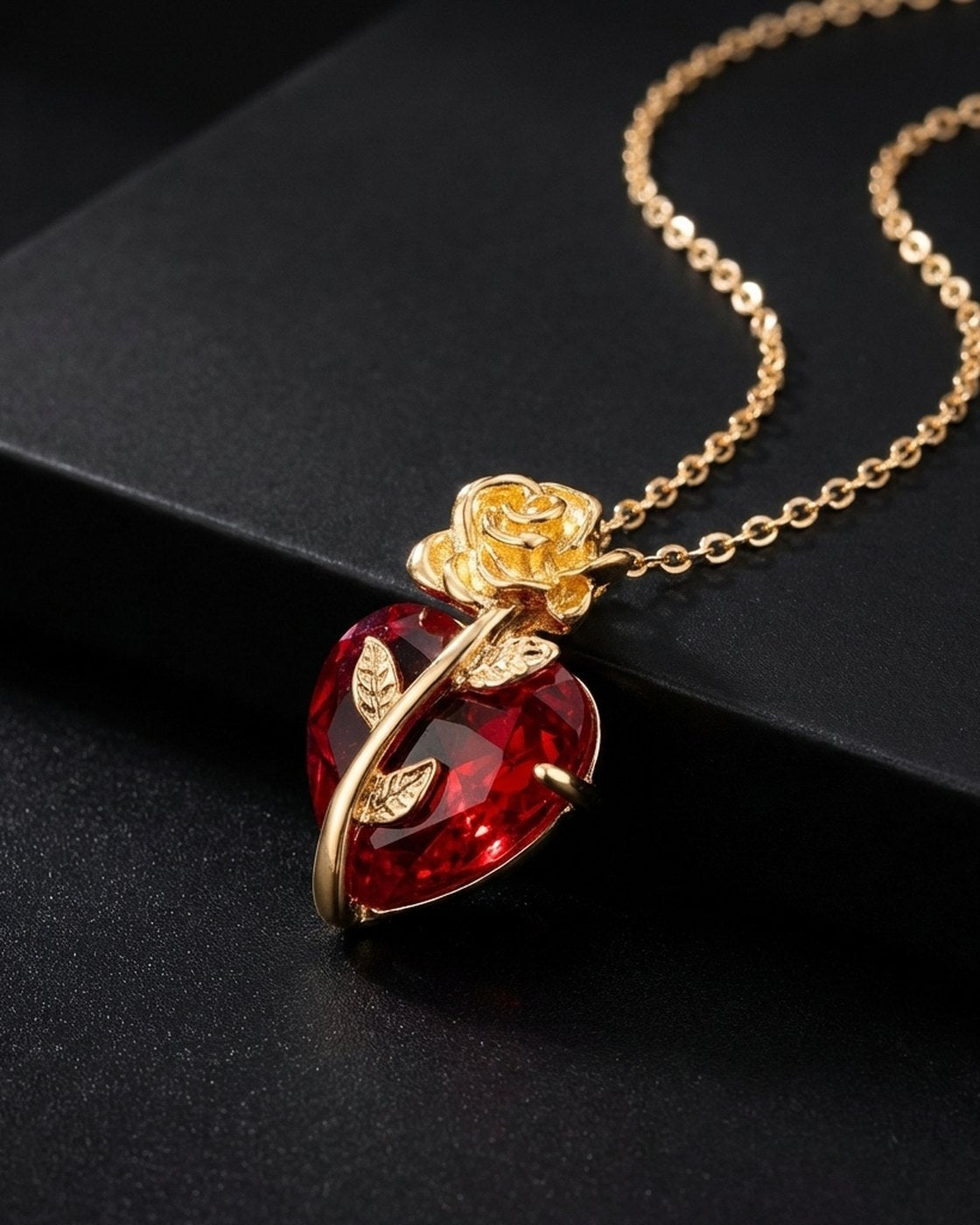 The Pomence Blood Rose Necklace in Gold on a dark background