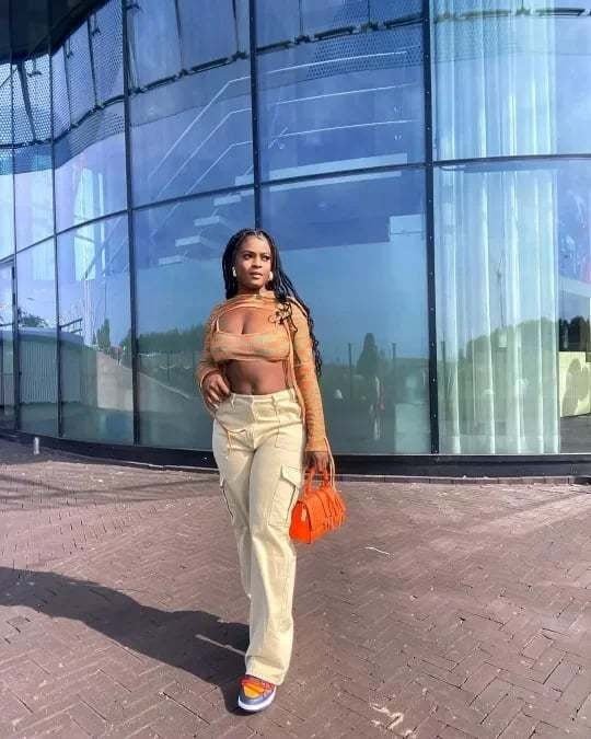 Woman in khaki cargo pants with a thigh flap pocket, walking outside