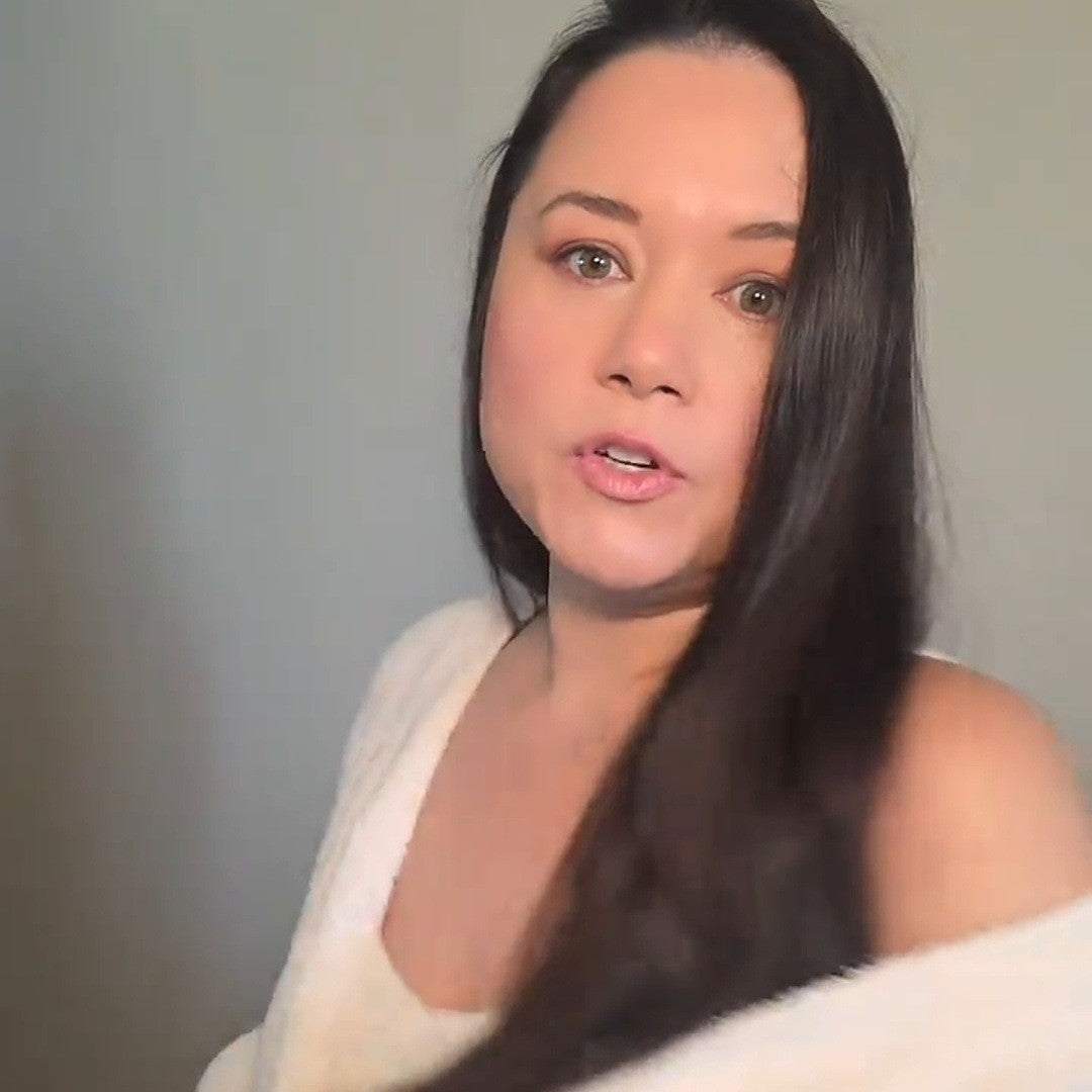 Woman hugging a fuzzy Ivory cardigan to her shoulder