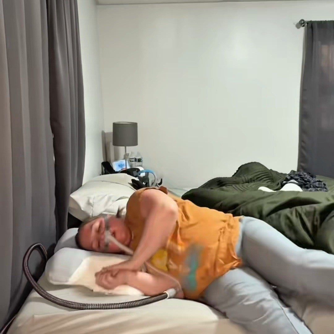 CPAP user hugging her contour pillow in her bedroom