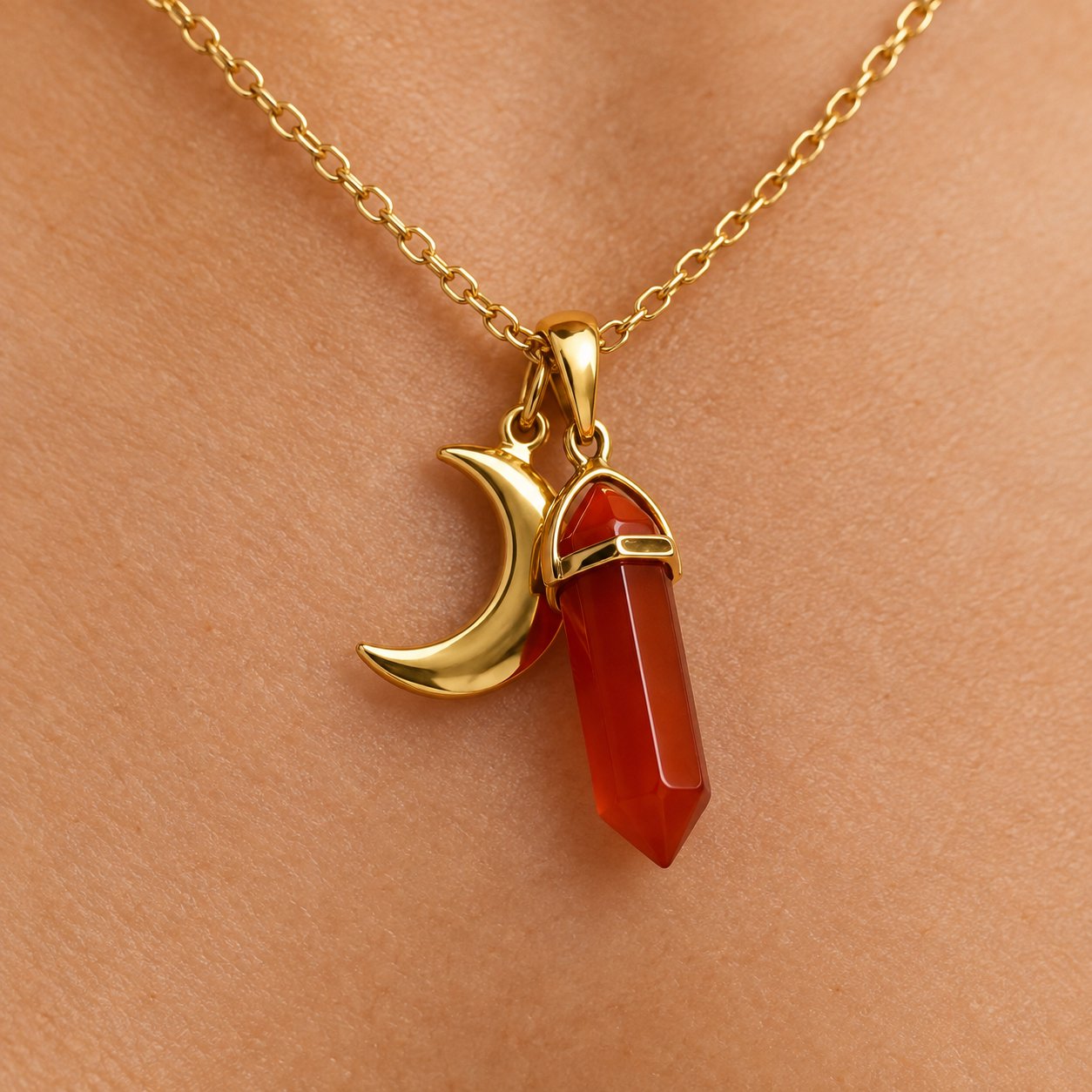 Macro of the small gold crescent moon charm on the shorter second chain
