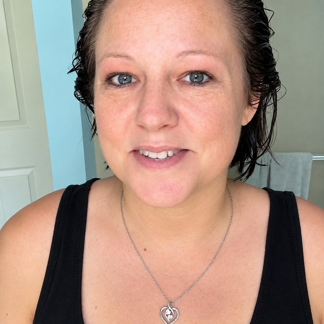 Woman with wet, freshly colored hair waiting at home