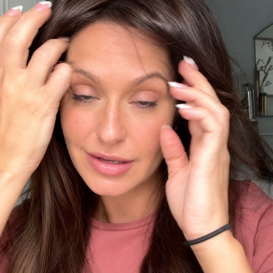 Woman running her hands through soft brown hair