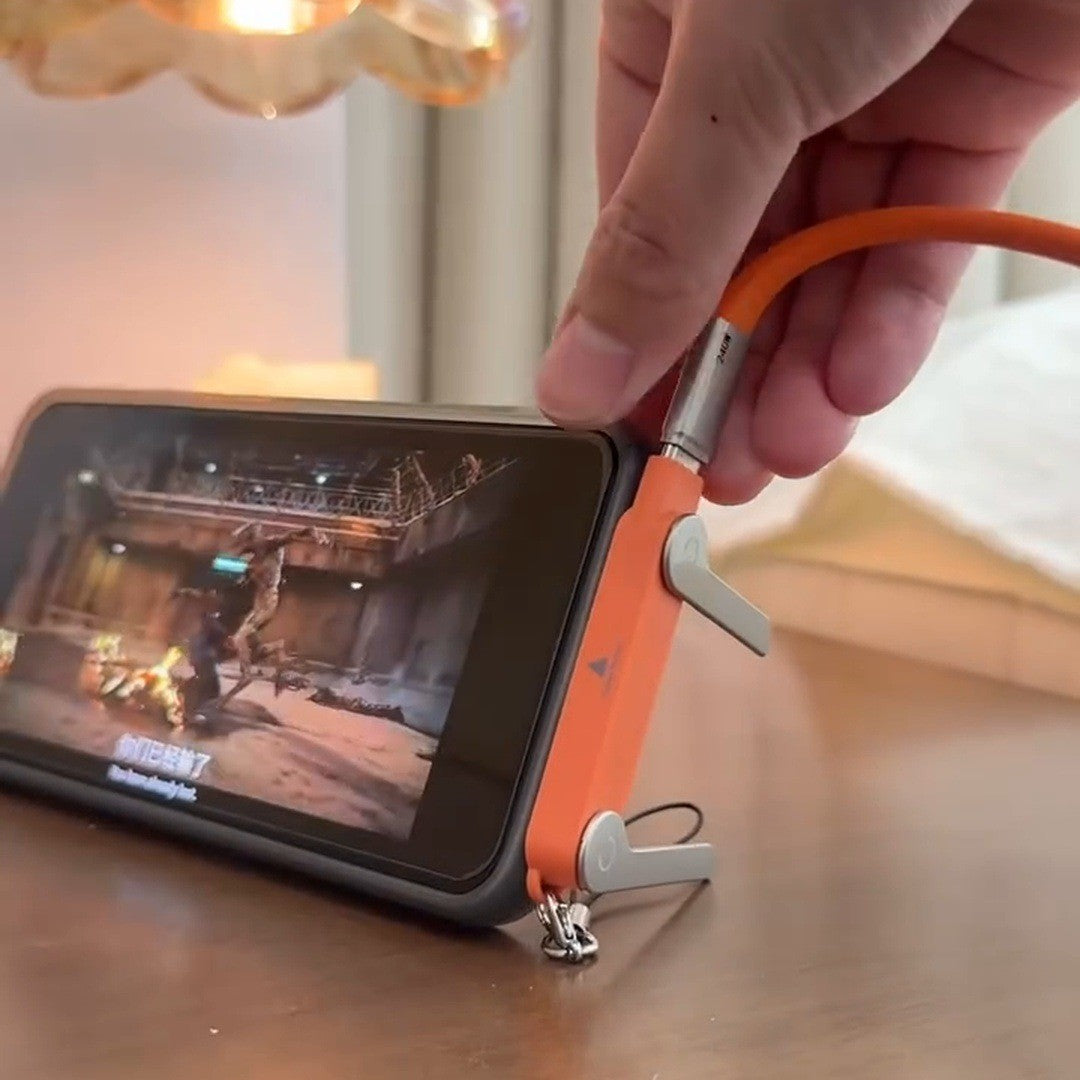 Phone standing sideways on the orange plug on a nightstand