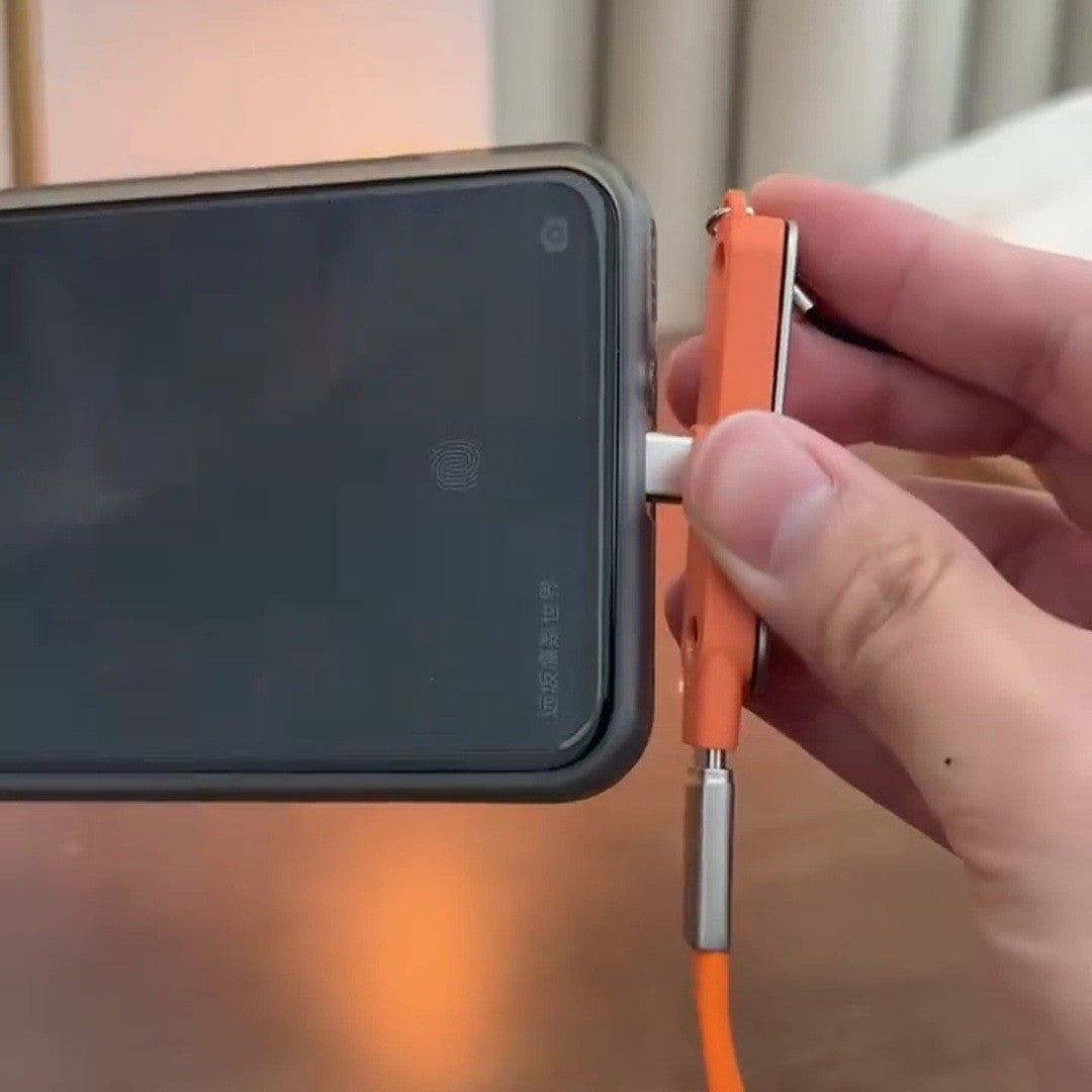Hand holding a phone sideways with the orange angled plug