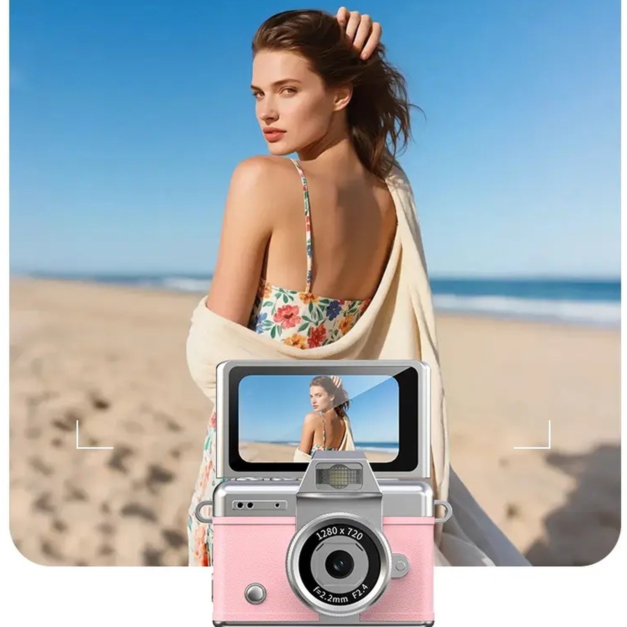 A woman on a beach seen on the flipped-up screen of the pink Pomence Mini Keychain Camera while it records