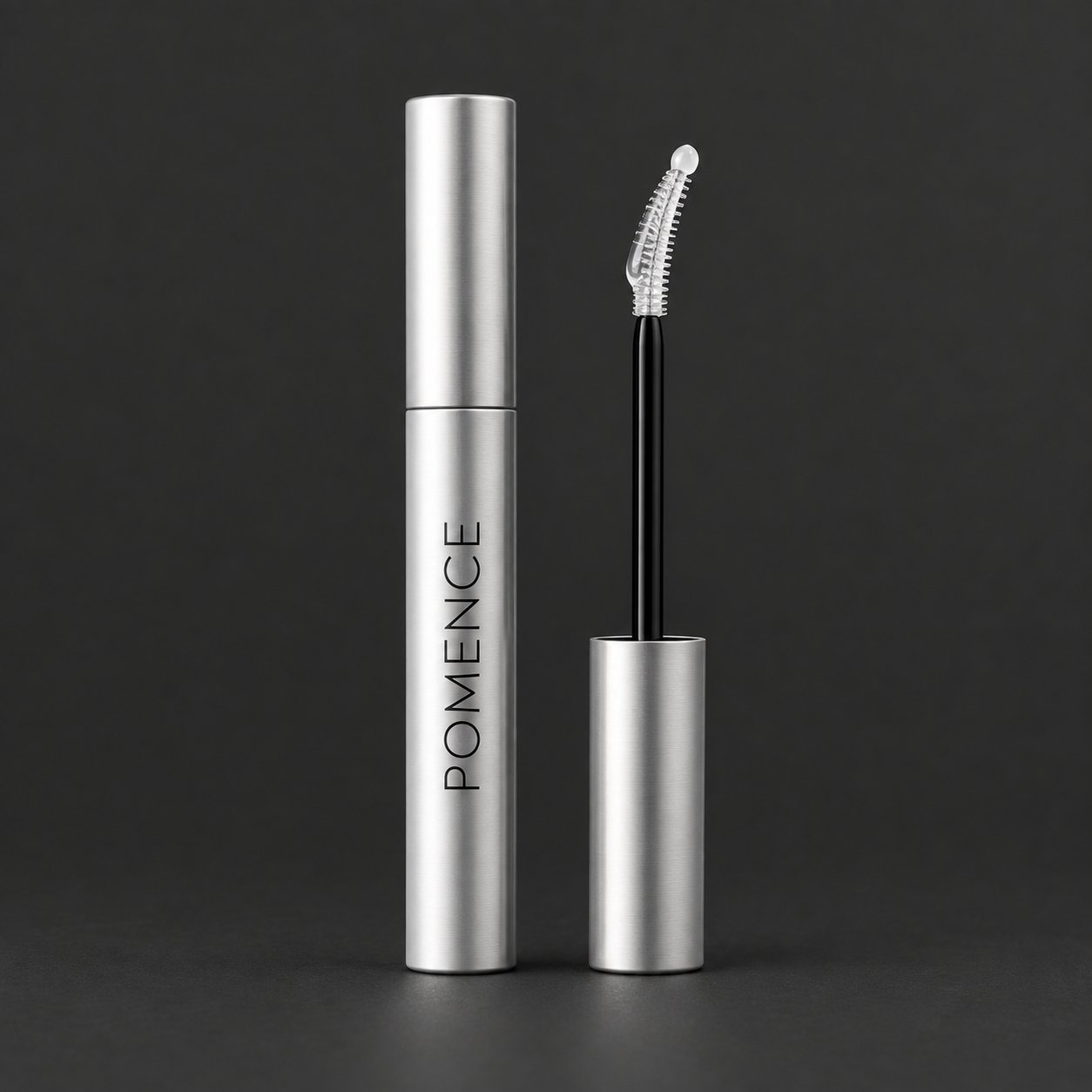 The silver Pomence Eyelash Growth Serum tube standing on a dark background