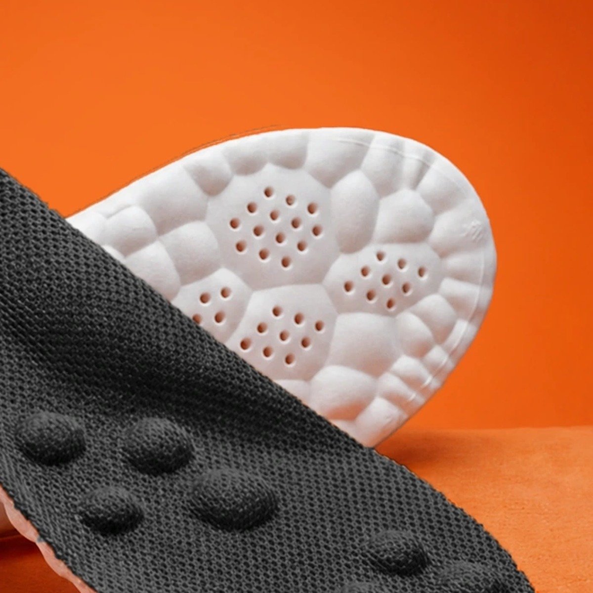 Close-up of the raised massage nodes on the black knit deck of the Pomence Massage Insoles