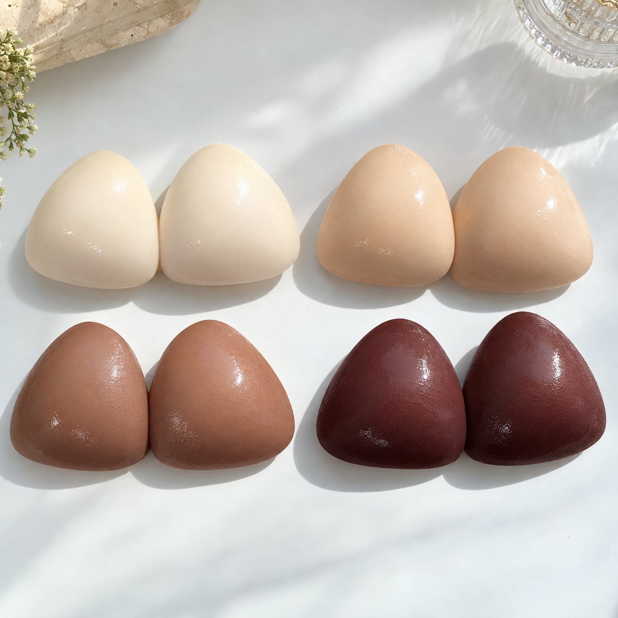 Four shades of Pomence sticky bra inserts side by side