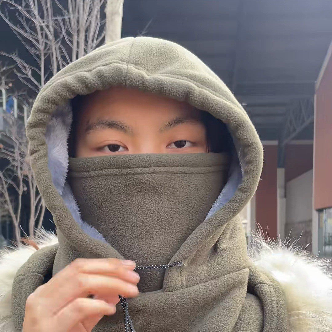 Woman in a parka with the green face cover pulled up to her eyes