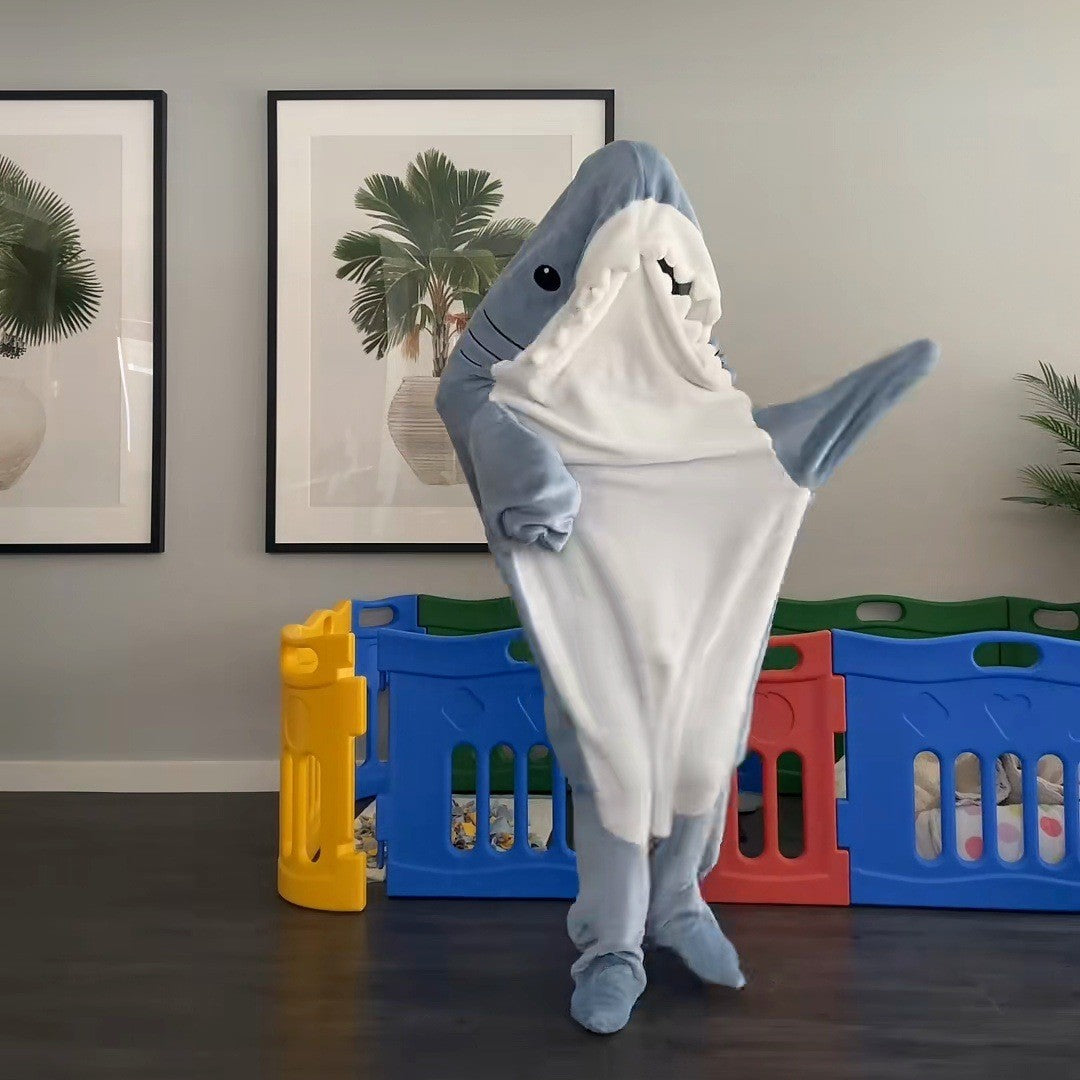 Person dancing in a shark blanket with fins out wide