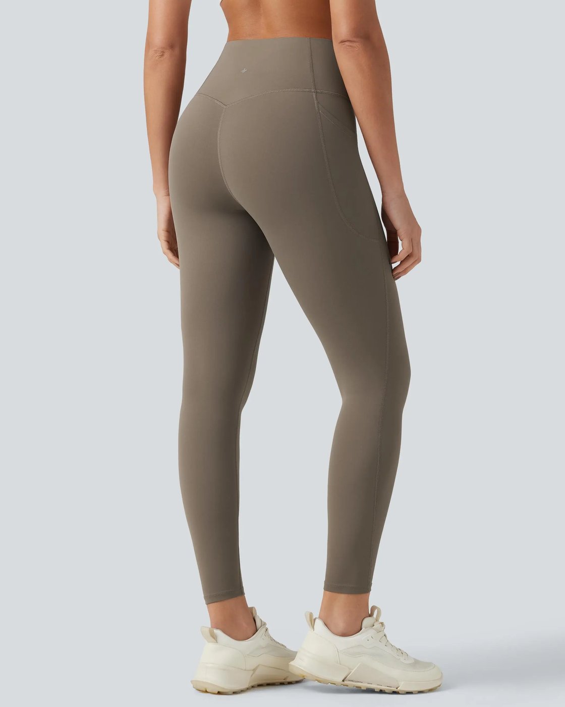 Back view of a woman standing in the Pomence high waisted tummy control sculpt leggings